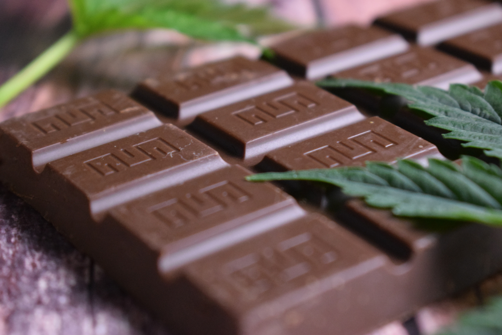 Marijuana,Leaf,And,Chocolate,On,Brown,Wooden,Background